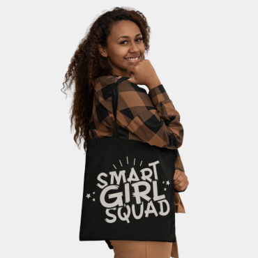 Woman smiling while wearing her smart girl squad tote bag